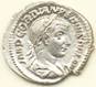 A silver coin with a person's face on it

Description automatically generated with medium confidence